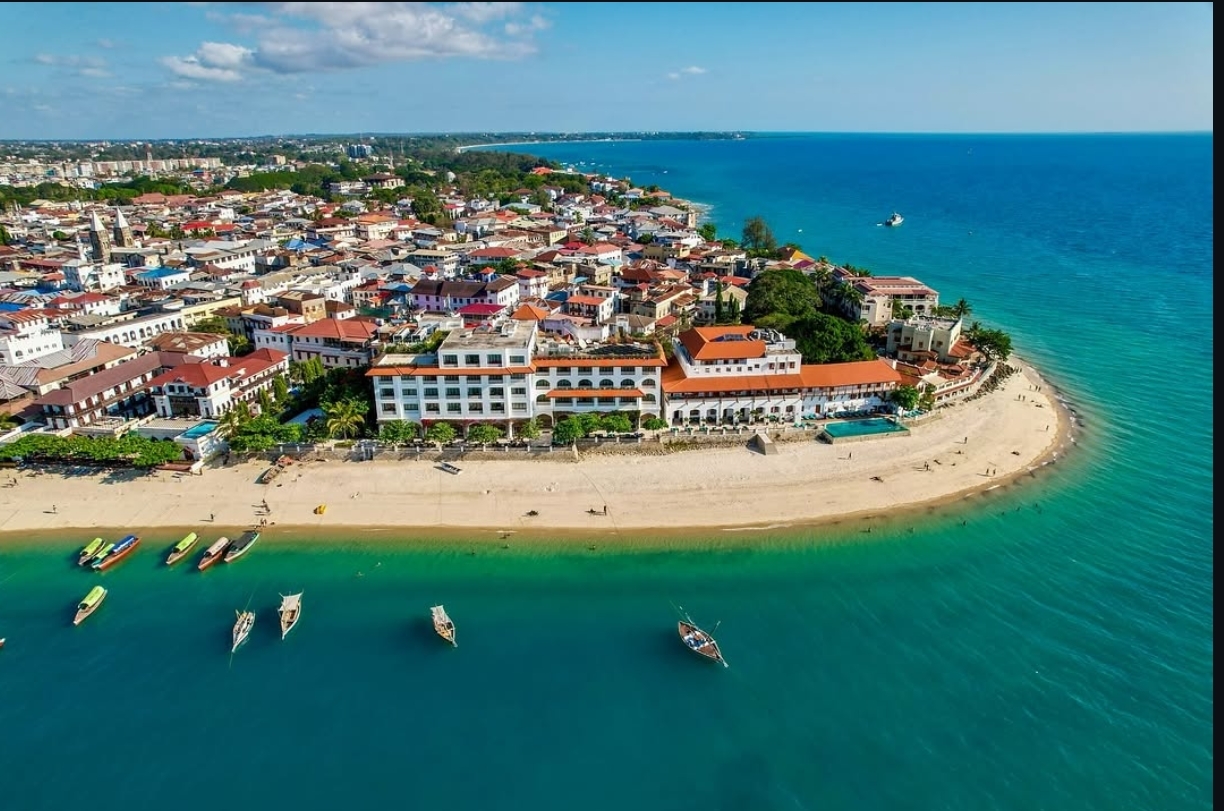 Aerial view across the historic rooftops and Indian Ocean edge of Stone Town