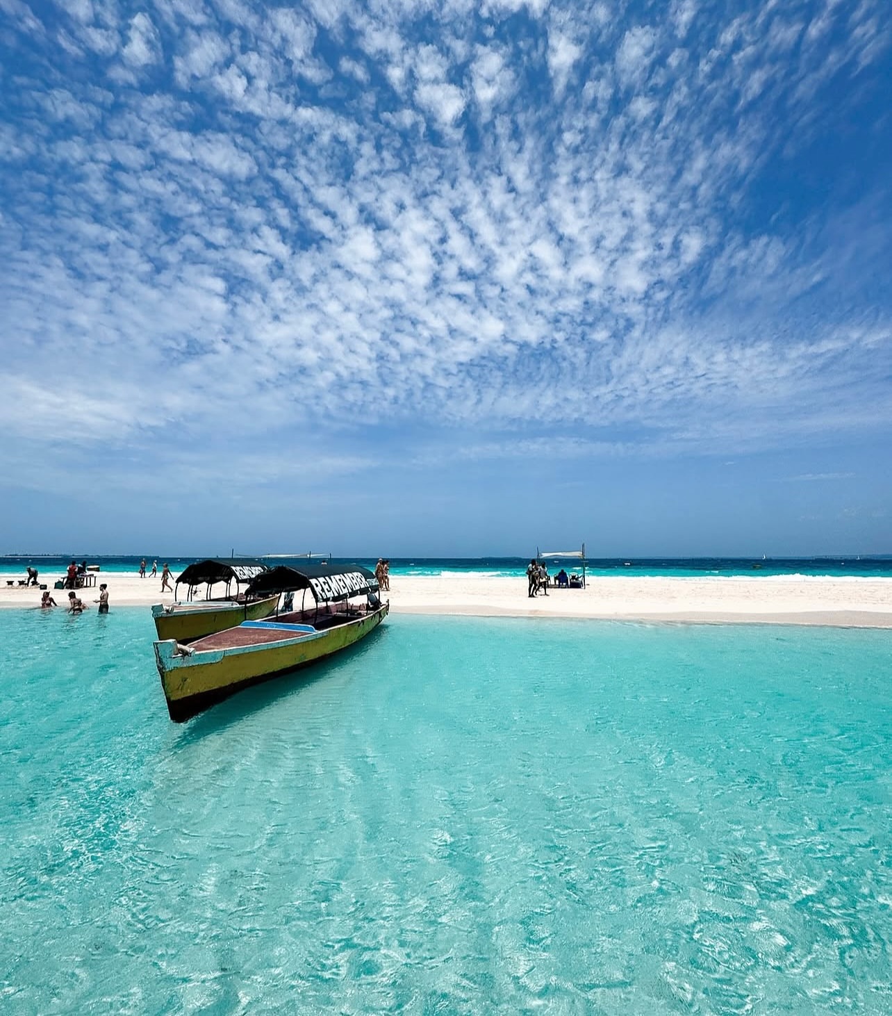 Nakupenda Sandbank with a traditional boat in shallow water