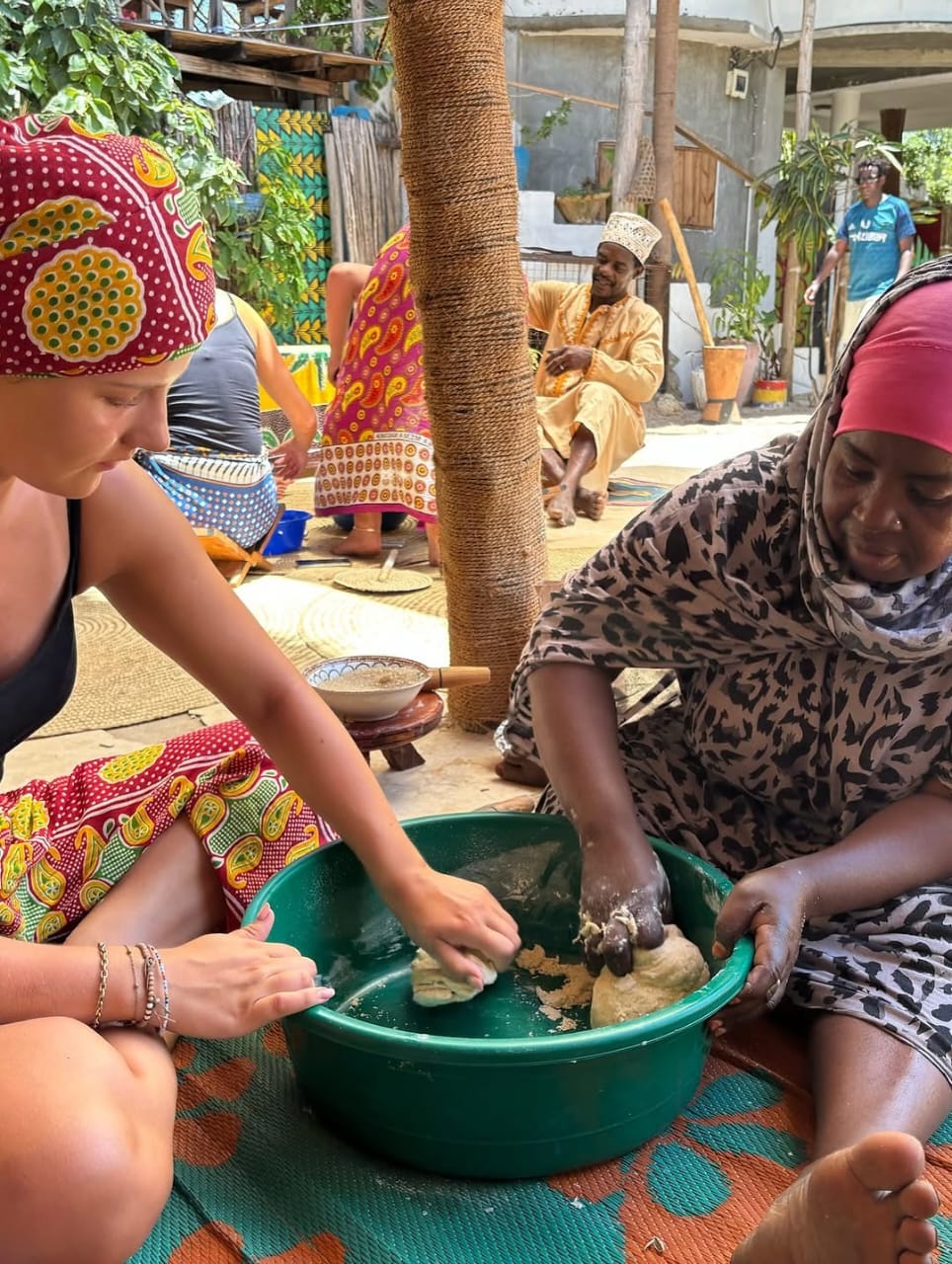 Travellers preparing dough with a local Swahili cooking host