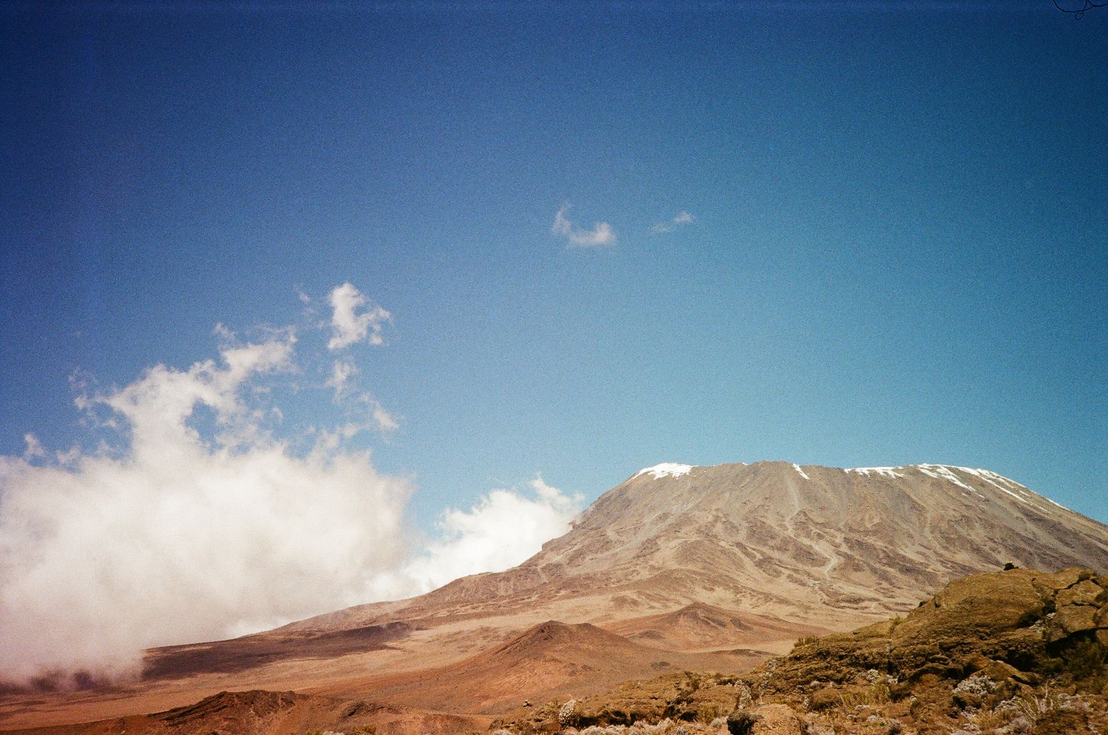 A high volcanic slope under a blue sky